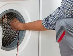 Dryer repair technician diagnosing and servicing a clothes dryer in Charlotte, NC