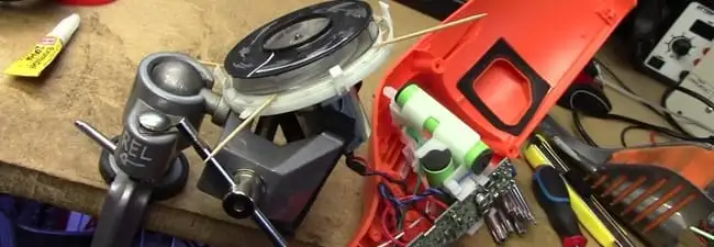 Vacuum cleaner repair parts and tools on a workbench in Charlotte, NC