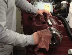 Vacuum repair technician cleaning and servicing a vacuum motor in Charlotte, NC