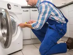 Washing machine repair technician servicing a front-load washer in Charlotte, NC
